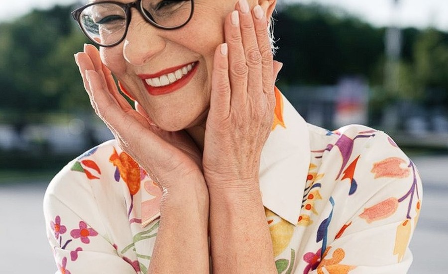 Elderly woman with beautiful white smile — confident after All-on-4 dental implants